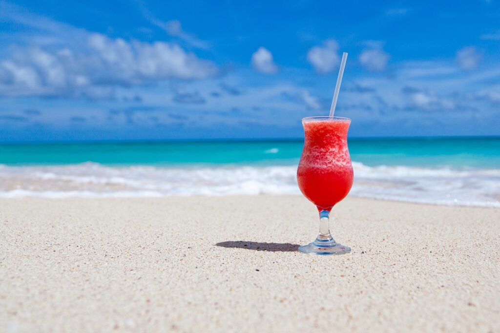 Beach background with frozen tropical drink to relaxing at your timeshare exchange