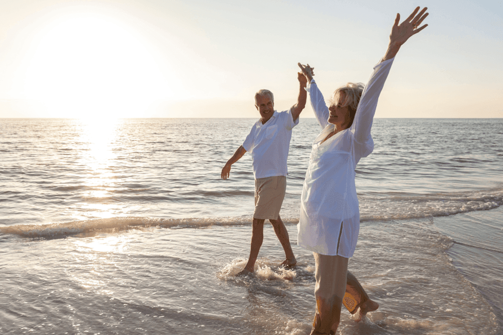 timeshare cancellation, happy senior couple on beach