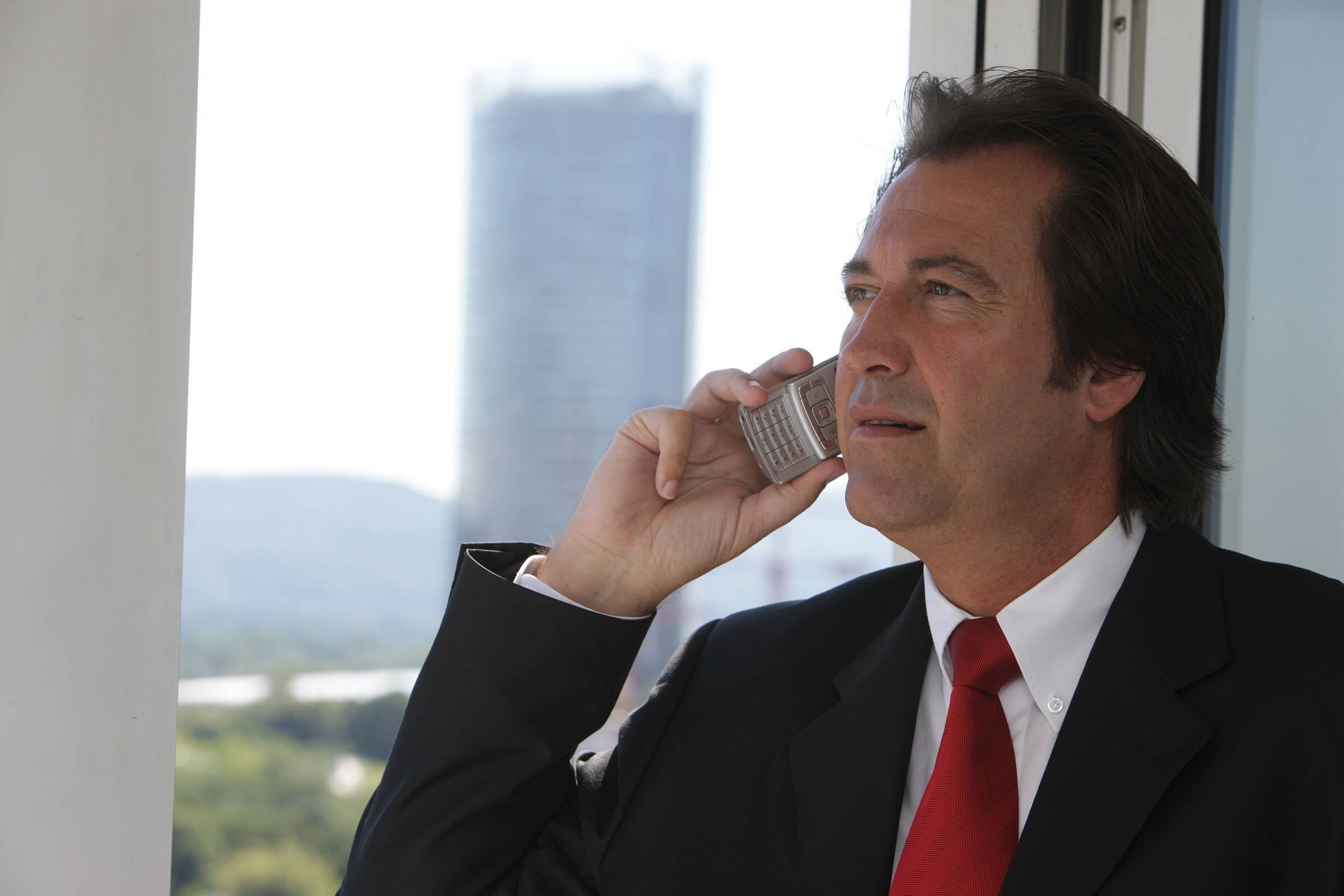 Lonestar Transfer, man talking on phone next to window