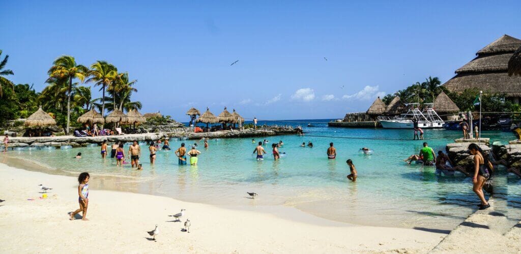 Palace Resorts Review Palace Resorts Review, people swimming in Mexico beach