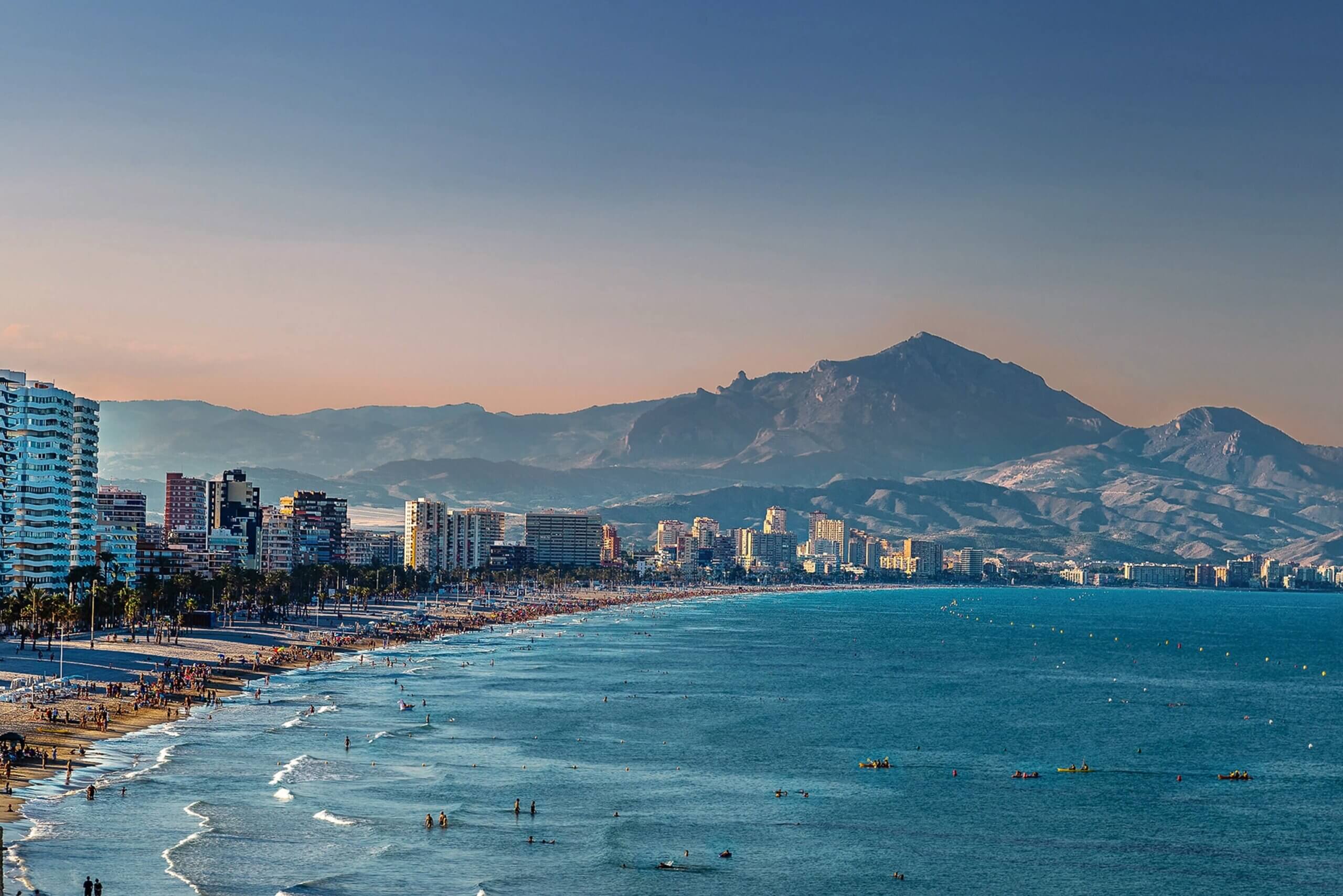 hiltn grand vacations review, city beach with mountains inbackground